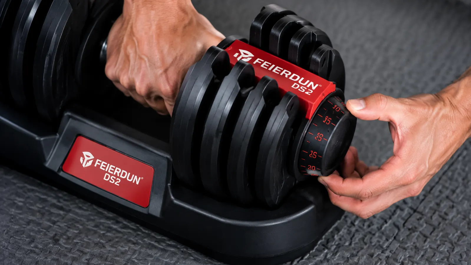 Person turning the weight selector dial on an adjustable dumbbell before starting a set