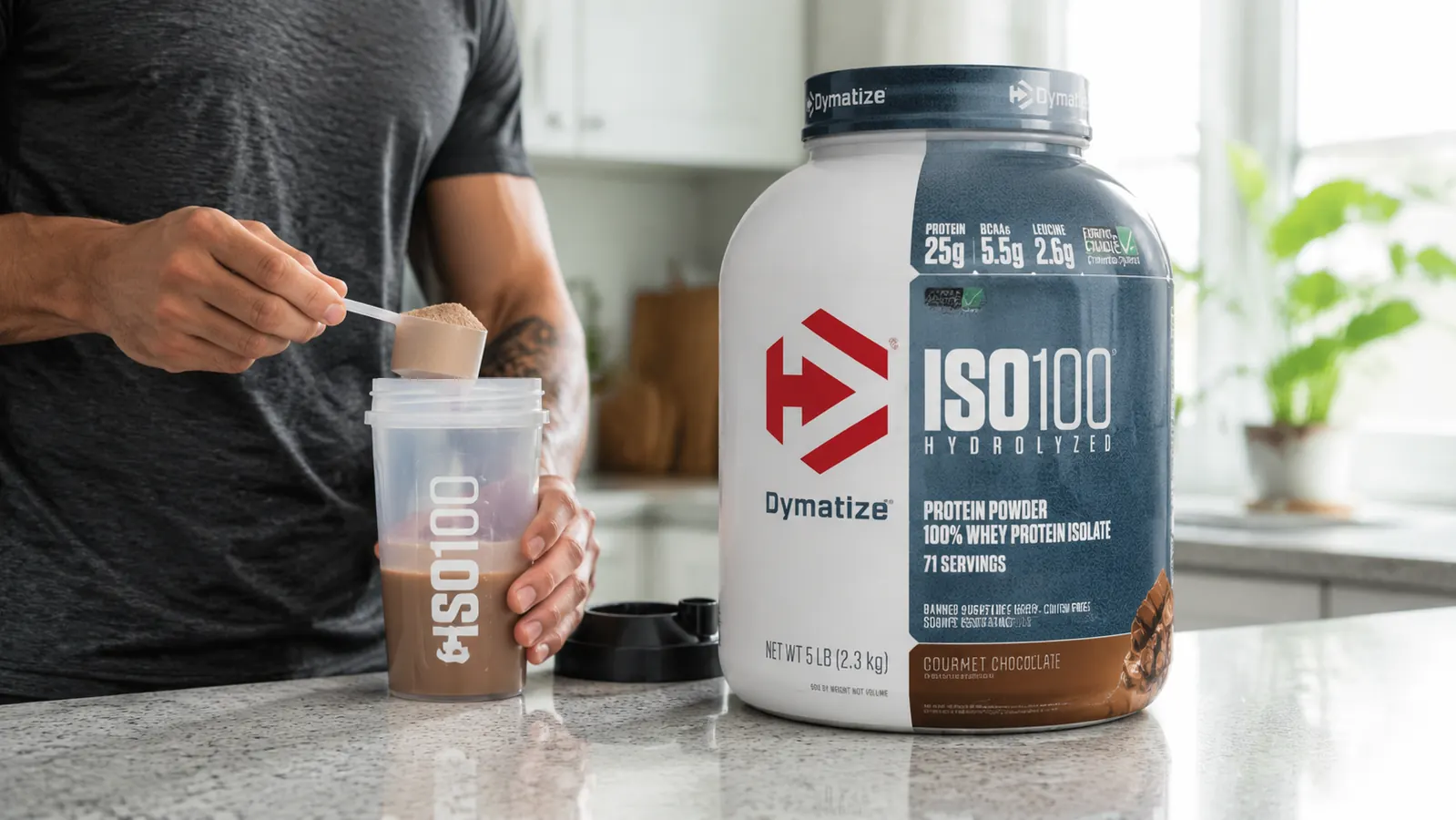 Dymatize ISO100 Gourmet Chocolate container sitting on a kitchen counter next to a shaker bottle