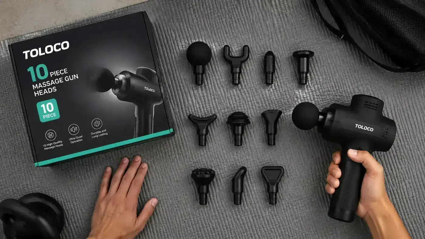 Close-up of the TOLOCO massage gun case open with all 10 attachments laid out